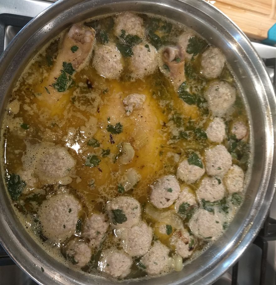 Meatballs coming to the top before removing the whole chicken